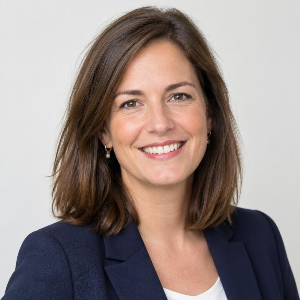 Portrait of a smiling woman with brown hair in a professional setting